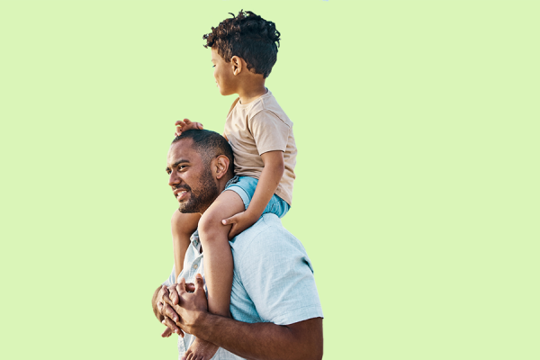 Man smiling with child on his shoulders