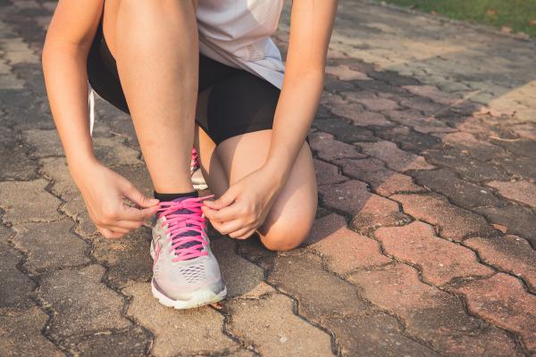 Woman tying shoelaces during excercise